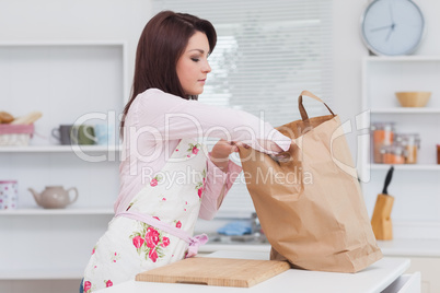 Woman with vegetable bag in the kitchen