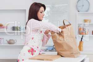 Woman with vegetable bag in the kitchen