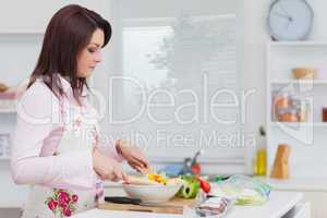 Woman preparing salad in the kitchen