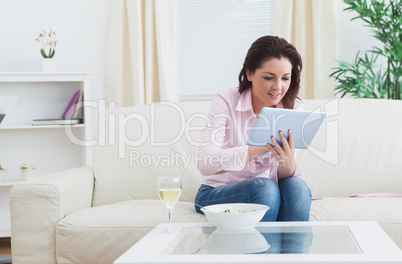 Casual woman using digital tablet at home