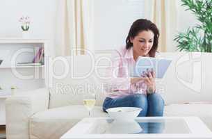 Casual woman using digital tablet at home