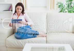 Casual woman using digital tablet at home