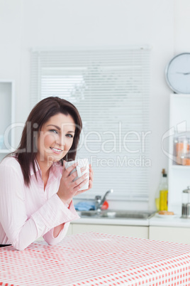 Portrait of happy young woman with coffee cup