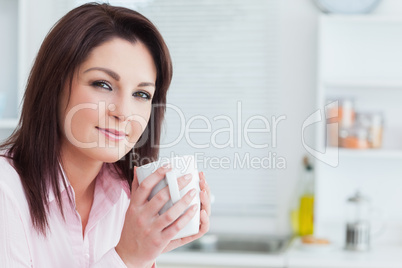 Close-up portrait of woman with coffee cup