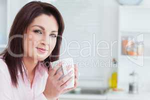 Close-up portrait of woman with coffee cup