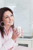 Woman looking away while drinking coffee