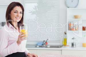 Smiling woman with orange juice