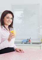 Smiling young woman with orange juice