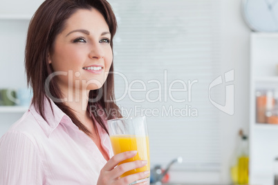 Close-up of smiling woman with orange juice