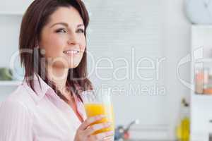 Close-up of smiling woman with orange juice