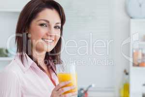 Smiling woman with orange juice