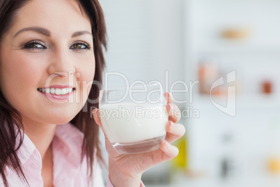 Close-up of young woman with glass of milk