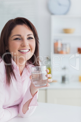 Portrait of young woman with glass of water