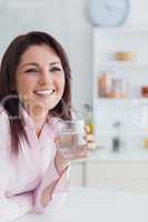 Portrait of young woman with glass of water