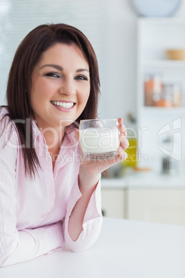 Close-up of young woman with glass of milk