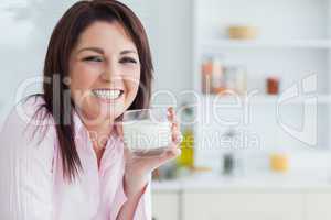 Portrait of woman with glass of milk