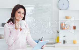 Woman with coffee cup and digital tablet