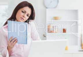 Woman on call while using digital tablet and laptop