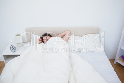 Woman yawning in bed