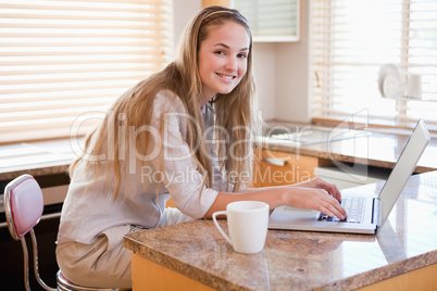 Portrait of smiling woman using laptop