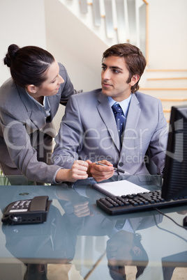 Business colleagues looking at each other at office Business colleagues looking at each other at office