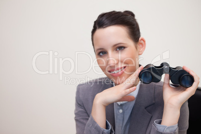Portrait of business woman with binoculars smiling