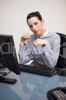 Business woman sitting in front of desktop computer