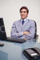 Business man sitting in front of desktop computer