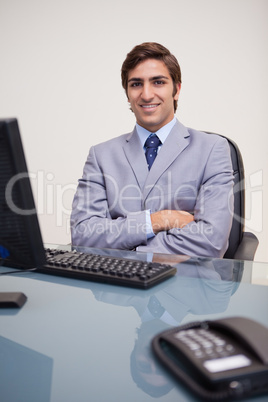 Portrait of business man sitting in front of desktop computer