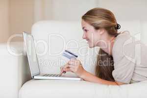 Side view of casual woman doing online shopping