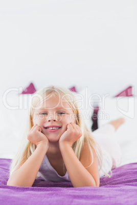 Little girl lying on a bed