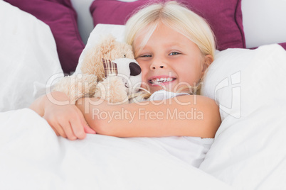 Little girl embracing her cuddly toy