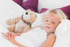 Cute girl sleeping near to her teddy bear