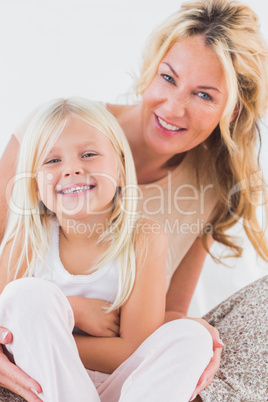 Mother and child sitting on a bed