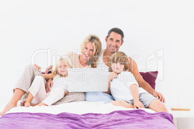 Happy family using the laptop together