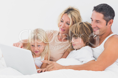 Family watching a laptop screen together