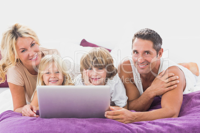 Smiling family using laptop Smiling family using laptop