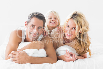 Family posing lying on a bed