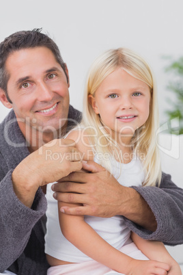 Smiling father hugging his daughter