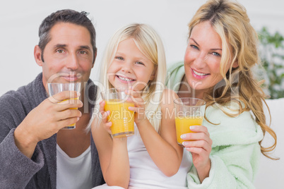 Family drinking glasses of orange juice