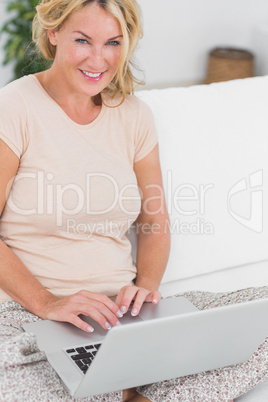 Blonde woman using a laptop