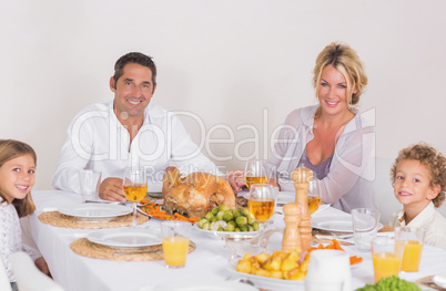 Family sitting on table to eat