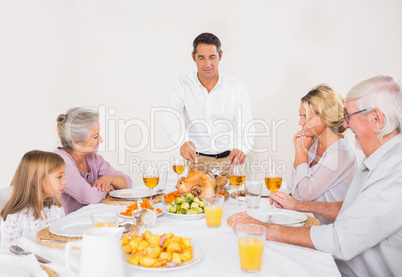 Father cutting slices of turkey