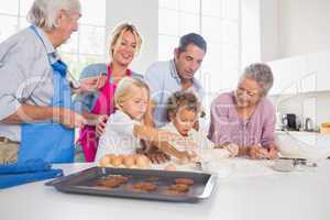 Family preparing biscuits together