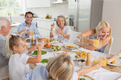 Happy family raising their glasses together