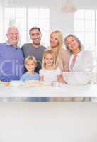 Smiling family posing in the kitchen