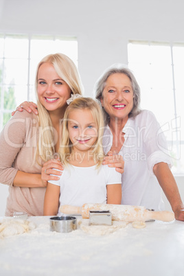 Smiling mothers and daughters cooking together