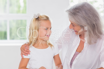 Smiling grandmother talking with her granddaughter