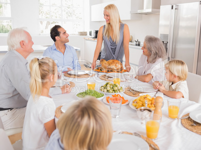 Family looking at the mother with a turkey plate