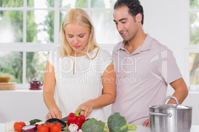 Husband looking at his wife cooking